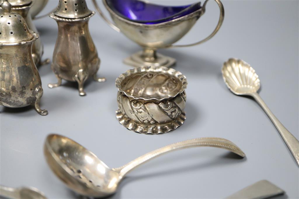 A pair of Edwardian silver boat shaped salts, three silver pepperettes and a small group of silver and plated flatware,